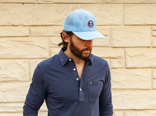 light blue mesh hat and navy polo